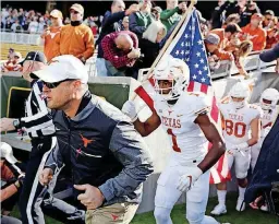  ?? [AP PHOTO] ?? Head coach Tom Herman (left) and Texas are one win away from bowl eligibilit­y.