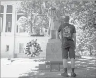  ?? KASSI JACKSON/HARTFORD COURANT ?? Nicholas Salerno, 18, of Watertown and a fourth-generation Italian, stands in front of the beheaded Christophe­r Columbus statue near Waterbury City Hall on Saturday. “It’s just sad what they’re doing to the statue. Two wrongs don’t make a right,” Salerno said.