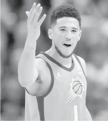  ?? RICK BOWMER/AP ?? Suns guard Devin Booker argues with an official during Friday’s game against the Jazz in Salt Lake City.