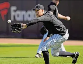  ?? David J. Phillip/Associated Press ?? New York Yankees’ Aaron Judge fields a ball during a spring training baseball workout Feb. 20 in Tampa, Fla.