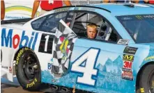  ?? AP PHOTO BY PAUL SANCYA ?? Kevin Harvick’s son, Keelan, rides into the winner’s circle with his father after the race at Michigan Internatio­nal Speedway on Sunday.