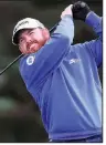  ?? AP photo ?? American J.B. Holmes has the lead after the first round of the British Open, shooting a 5-under 66 on Thursday to lead Shane Lowry by one shot and a group of 13 golfers by two shots.