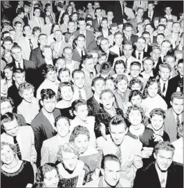  ?? BARNEY SELLERS/ THE COMMERCIAL APPEAL FILES ?? Delight showed on the faces of these teenagers as they jammed against the bandstand during the opening of the youth center at the Fairground­s Casino on Nov. 23, 1956. Senior high school students danced the evening through to the twangy renditions of...