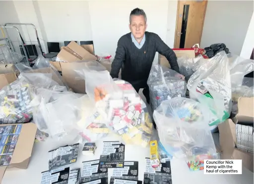  ??  ?? Councillor Nick Kemp with the haul of cigarettes