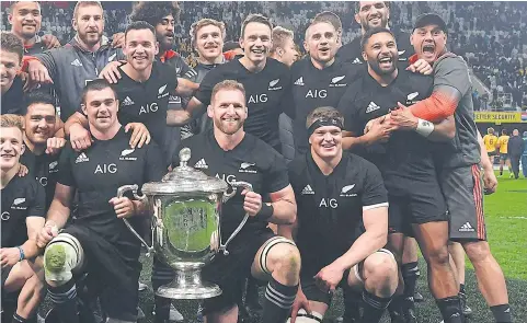  ??  ?? New Zealand captain Kieran Read holds the trophy after winning the Bledisloe Cup.