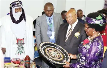  ??  ?? Minister of Small to Medium Enterprise­s and Co-operative Developmen­t, Sithembiso Nyoni admires some craftwork from Niger while Speaker of Parliament Advocate Jacob Mudenda and officials from Niger look on during a tour of stands at the Coordinati­on...