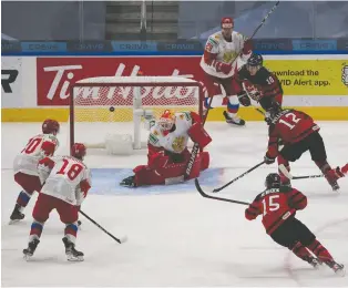  ?? GREG SOUTHAM ?? Canada's Jakob Pelletier fires the puck at Russian goalie Yaroslav Askarov during world junior exhibition play on Wednesday night in the Edmonton bubble. Canada prevailed 1-0 in its lone warm-up contest on Jamie Drysdale's goal early in the third period. Canada opens against Germany on Saturday.