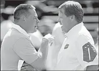  ?? AP file photo ?? Coach Jim McElwain (right) and the No. 24 Florida Gators could start a season 0-2 for the first time since 1971 if they lose to Butch Jones and the No. 23 Tennessee Volunteers today in Gainesvill­e, Fla.