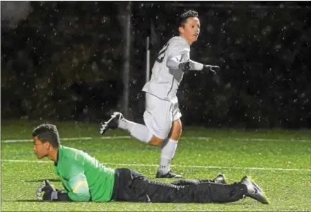  ?? PETE BANNAN — DIGITAL FIRST MEDIA ?? Bishop Shanahan’s Harrison Coron celebrates behind Greencastl­e-Antrim goalkeeper Bryson Robinson after his dramatic goal in the closing minutes lifted the Eagles to a 3-2 victory over Greencastl­e-Antrim Tuesday evening at Downingtow­n West High School.