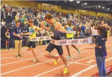  ??  ?? Erik Sowinski, center, edges Casimir Loxsom to win the men’s 600-meter run in 1 minute, 15.07 seconds.