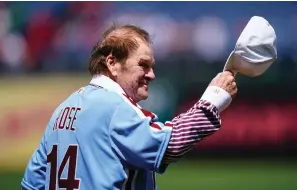  ?? The Associated Press ?? Former Philadelph­ia Phillies player Pete Rose tips his hat to fans during an alumni day event before a game between the Philadelph­ia Phillies and the Washington Nationals Sunday in Philadelph­ia.