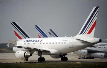  ??  ?? An Airbus A318-111 with the Air France livery parked on the tarmac of Paris’ Roissy-Charles de Gaulle airport in Roissy during an Air France pilots strike. Air France staff stage on April 10 and 11, 2018 a two-day strike, the latest in a series pushing...