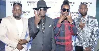  ?? FILE ?? Director, producer and screenplay writer of ‘The Intent 2’, Femi Oyeniran (left), and director Nicky Slimting (right) with cast members Teddy Bruck Shut (second left) and Popcaan.