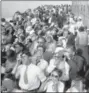  ?? THE ASSOCIATED PRESS ?? Eclipse watchers squint through protective film as they view a partial eclipse of the sun from the top deck of New York’s Empire State Building in New York. Destinatio­ns are hosting festivals, hotels are selling out and travelers are planning trips for...