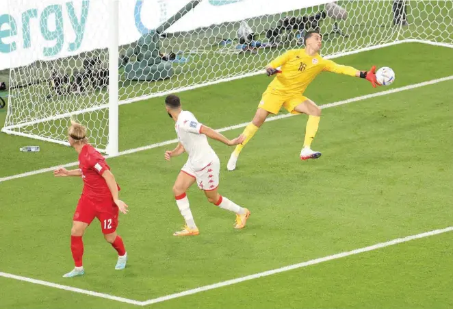  ?? — Reuters ?? Tunisia goalkeeper Aymen Dahmen makes a save against Denmark in their World Cup Group D opener at Education City Stadium.