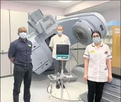  ??  ?? From left: Innocent Neshiri, Geraint Rees and Elina Hajichrist­ou, Oncology Centre staff, with the new scanner