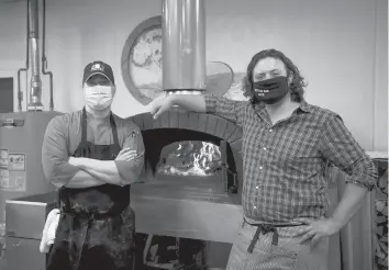  ?? KASSIJACKS­ON/HARTFORD COURANT ?? Little Oak Cafe co-owners David Borselle, left, and Jeff Fiorino, stand by their pizza oven imported from Italy. The pair met while working at West Hartford’s Park & Oak before it closed in July as a result of the pandemic.