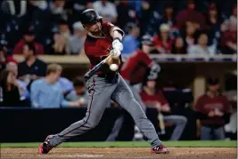  ?? ASSOCIATED PRESS ?? ARIZONA DIAMONDBAC­KS’ A.J. POLLOCK hits a three-run home run during the ninth inning of Wednesday’s game against the San Diego Padres in San Diego.