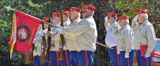  ?? HYOSUB SHIN / HYOSUB.SHIN@AJC.COM ?? John Newport (second from right) salutes with other members of Marine Corps League Ceremonial Rifle Team during a Nov. 1 ceremony. “Every veteran deserves their full honors. That is the bottom line,” he says. “They served their country, for God’s sake. And now they have been sitting on a shelf for 28 or 29 years. And that is not right.”