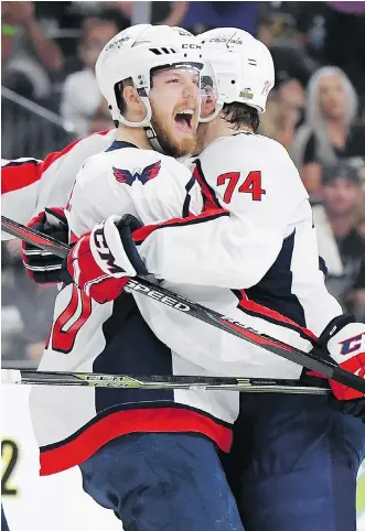  ?? HARRY HOW/GETTY IMAGES ?? Lars Eller, left, gets a hug from John Carlson after scoring Washington’s first goal Wednesday in a 3-2 win over the Golden Knights in Game 2 of the Stanley Cup final at T-Mobile Arena in Las Vegas.