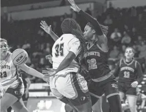  ?? LIAM KENNEDY/THE TENNESSEAN ?? Briarcrest Christian Saints forward Milan Carroll (35) passes the ball behind her back to teammate Kayli Clarkson (23) during the division II semifinals at the Hooper Eblen Center in Cookeville on Friday.