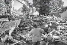  ?? Mark Mulligan/Staff photograph­er ?? Annie Green looks at the remains of the Houston home where she has lived for 46 years after it was demolished in 2020.