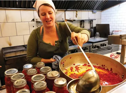  ?? EZRa SOIFERMAN ?? Emma Cardarelli ladles red pepper salsa at Nora Gray. When her mentor encouraged her to open a restaurant, she says, “it really made me feel like I could do anything.”