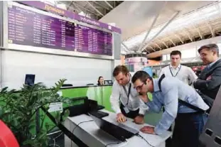  ??  ?? KIEV, UKRAINE: Airport employees use a laptop computer at Boryspil airport. A new and highly virulent outbreak of malicious data-scrambling software appears to be causing mass disruption across Europe —AP