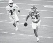  ?? KYUSUNG GONG AP ?? Chiefs quarterbac­k Patrick Mahomes runs against the Chargers during overtime on Sunday.