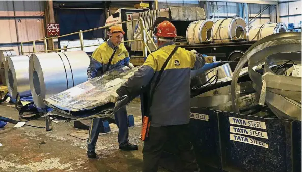  ?? — Reuters ?? Steel takeover: Workers moving waste metal at Tata Steel’s new robotic welding line at their automotive service centre in Wednesfiel­d, Britain. Mumbaibase­d Tata has offered 352 billion rupees (US$5.1bil) in cash to acquire Bhushan Steel.