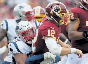  ?? NANCY LANE / BOSTON HERALD ?? Patriots defensive end Deatrich Wise gets to Washington Redskins quarterbac­k Colt McCoy during a game last season.