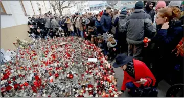  ??  ?? People light candles during a march in reaction to the murder of Kuciak and Kusnirova, in Bratislava. — Reuters photo