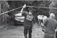  ?? MIKE VALERI/STANDARD TIMES VIA AP ?? Authoritie­s carry lighting equipment to the backyard of the home of Lillian Webb, wife of fugitive Donald Eugene Webb, in Dartmouth, Mass., on Thursday.