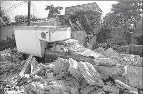  ?? AP/REBECCA BLACKWELL ?? Rubble from a collapsed building surrounds a truck Saturday in the hard-hit Mexican city of Juchitan.