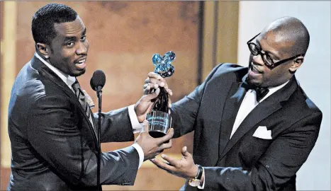  ?? NICK WASS/AP ?? Andre Harrell, right, presents an award to Sean “Diddy” Combs at the Warner Theatre during the 2010 BET Hip Hop Honors in Washington. Harrell died Friday at 59.