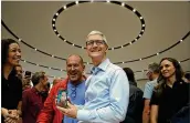  ?? JUSTIN SULLIVAN / GETTY IMAGES ?? Apple CEO Tim Cook (center) unveils the iPhone X Tuesday in Cupertino, Calif.