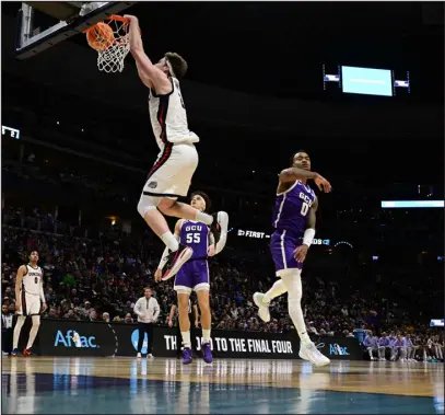  ?? ANDY CROSS — THE DENVER POST ?? Drew Timme of the Gonzaga Bulldogs slam dunks against Rayshon Harrison (0) of the Grand Canyon Antelopes in the second half during the first round of the NCAA Tournament at Ball Arena on Friday.