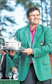  ??  ?? Patrick Reed celebrates with the trophy during the green jacket ceremony after winning the Agusta Masters Tournament.