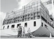  ?? Patrick Semansky / Associated Press ?? A container ship is unloaded in Baltimore. The U.S. trade deficit declined in September.