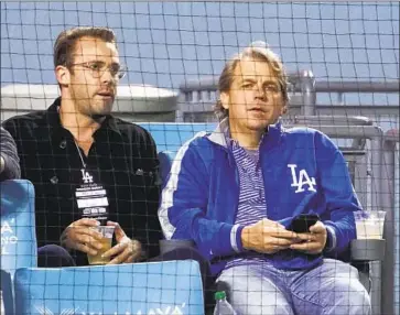  ?? Mark J. Terrill Associated Press ?? TODD BOEHLY, right, attends the Dodgers’ April 30 game against Detroit. The Dodgers part-owner led a group acquiring Premier League soccer club Chelsea FC for $3.1 billion, the highest sale price for a sports team.