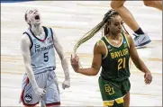  ??  ?? UConn’s Paige Bueckers celebrates in front of Baylor’s DiJonai Carrington after the Huskies beat the Lady Bears 69-67 to advance to the Final Four.