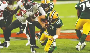  ?? MIKE EHRMANN/GETTY IMAGES FILES ?? Bucs linebacker Devin White sacks Packers QB Aaron Rodgers as Tampa Bay rallied from a 10-0 deficit to thump Green Bay at home back in October.