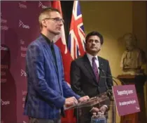  ?? GARY YOKOYAMA, THE HAMILTON SPECTATOR ?? Attorney General Yasir Naqvi, right, listens as former juror Mark Farrant talks about his struggles with PTSD. They were in Hamilton Tuesday to announce a program to help jurors who have been through difficult trials.