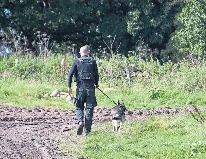  ?? Picture: Stuart Cowper. ?? An officer and a police dog on the outskirts of Perth.
