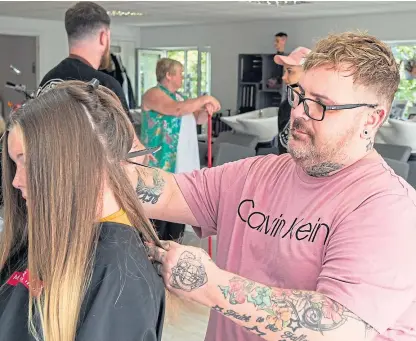  ?? Picture: Wullie Marr Photograph­y. ?? Craig Boyd opened his Leven salon yesterday to provide free haircuts to help children spruce up for the start of term.