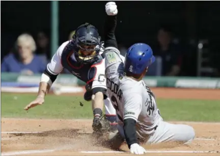  ?? TONY DEJAK — ASSOCIATED PRESS ?? The Royals’ Alcides Escobar slides safely into home plate as Indians catcher Yan Gomes attempts to tag him out in the first inning May 27 at Progressiv­e Field. Escobar scored on a sacrifice fly by Salvador Perez.