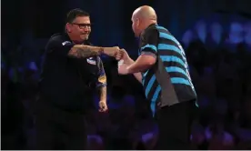  ?? Luke Walker/Getty Images ?? Gary Anderson touches in with Rob Cross after beating the 2018 champion. Photograph: