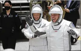  ?? JOHN RAOUX / ASSOCIATED PRESS ?? NASA astronauts Douglas Hurley (left) and Bob Behnken walk out of the Neil A. Armstrong Operations and Checkout Building on their way to Pad 39-A at the Kennedy Space Center on Wednesday.