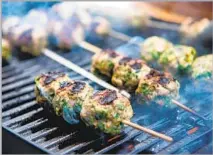  ?? Mariah Tauger Los Angeles Times ?? HERBS brighten and lighten these skewered meatballs, which are great for summer grilling and pair well with avocado dip.