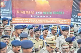  ??  ?? CRPF personnel hold candles and pay tribute to their colleagues in Hyderabad on Friday.